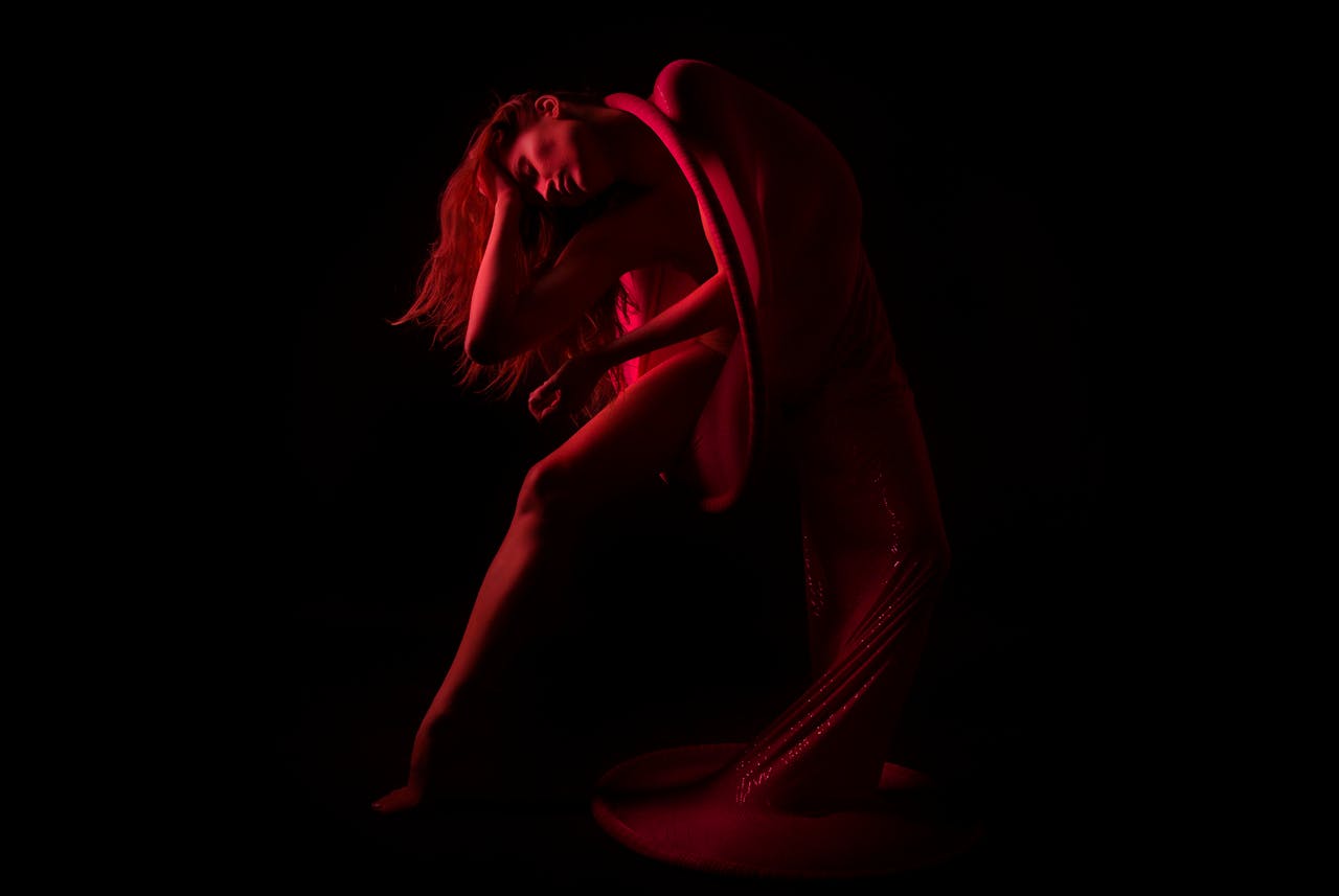 gallery-03 A captivating artistic nude image showcasing an elegant pose with dramatic lighting and shadows.